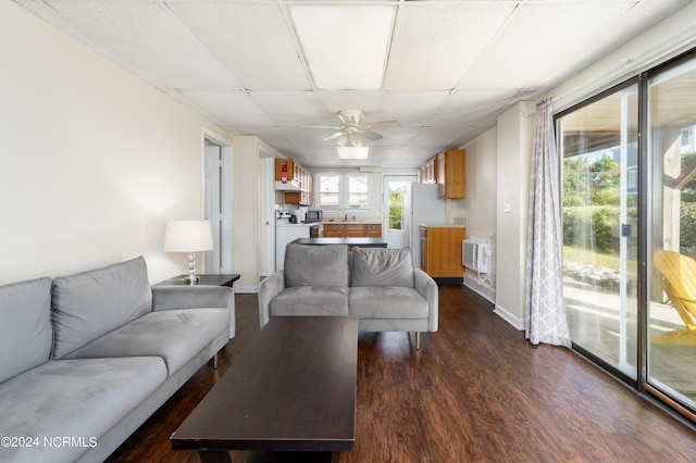 living room with ceiling fan and dark wood-type flooring