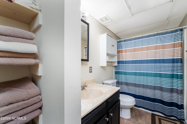 bathroom with walk in shower, vanity, and toilet