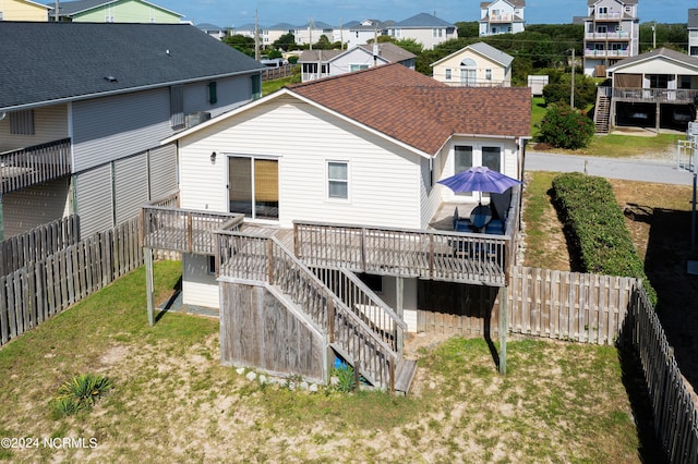 back of house with a wooden deck and a yard