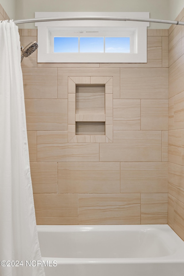 bathroom featuring shower / tub combo with curtain