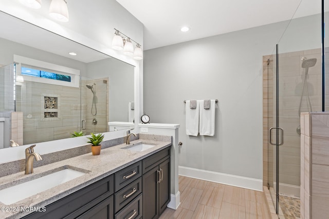 bathroom featuring vanity and a shower with door