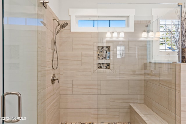 bathroom featuring a shower with door