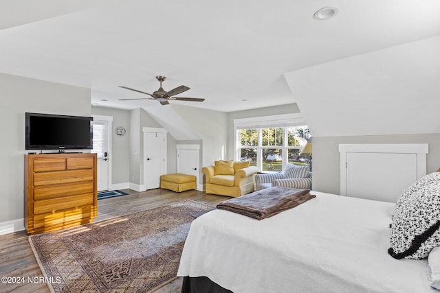 bedroom featuring lofted ceiling, wood-type flooring, and ceiling fan