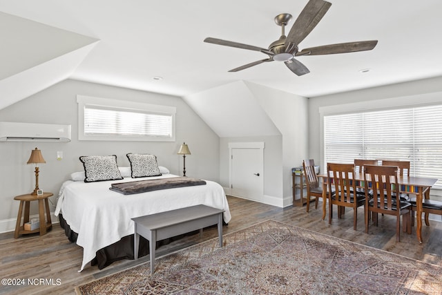 bedroom featuring lofted ceiling, dark hardwood / wood-style floors, and an AC wall unit