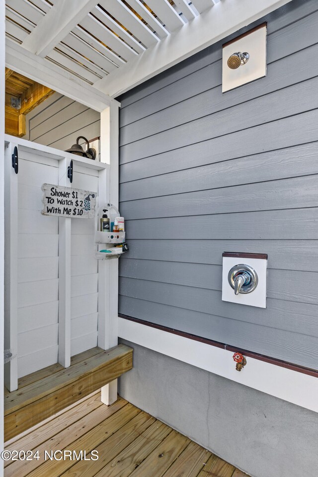 mudroom with light wood-type flooring and wood walls