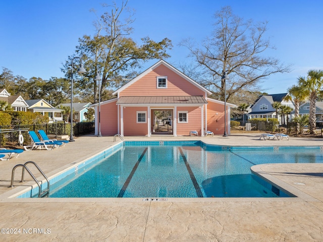 view of pool featuring a patio and an outdoor structure