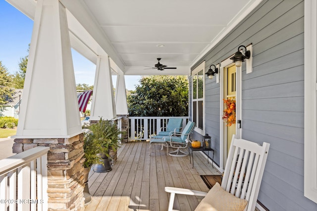 wooden deck with a porch and ceiling fan