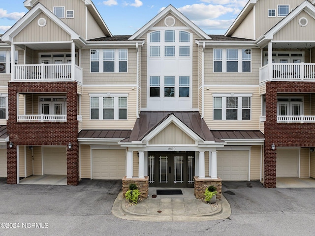 view of property featuring a balcony and a garage