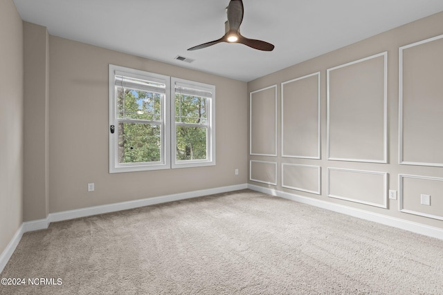 unfurnished room featuring ceiling fan and light colored carpet