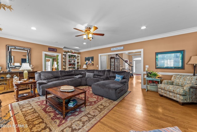 living area with light wood-style floors, recessed lighting, and ornamental molding