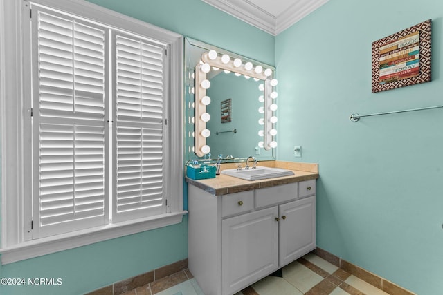 bathroom with crown molding, vanity, and baseboards