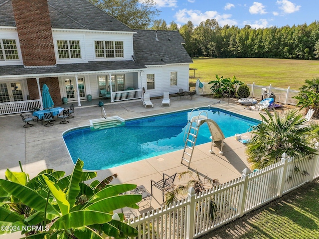 view of pool with a fenced in pool, a yard, a patio, a water slide, and a fenced backyard