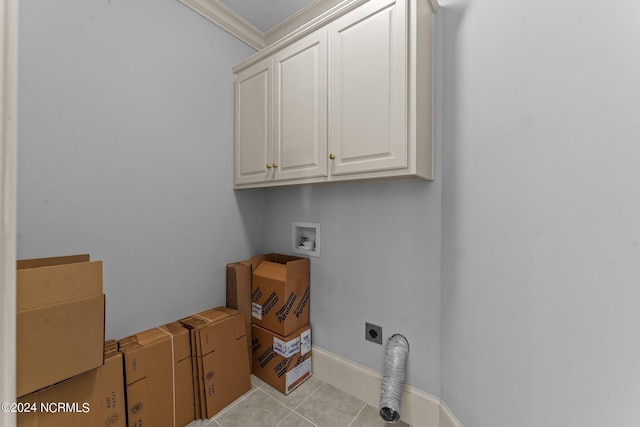 washroom featuring light tile patterned floors, hookup for an electric dryer, washer hookup, cabinet space, and crown molding