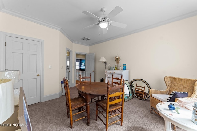 dining room with baseboards, visible vents, a ceiling fan, ornamental molding, and carpet