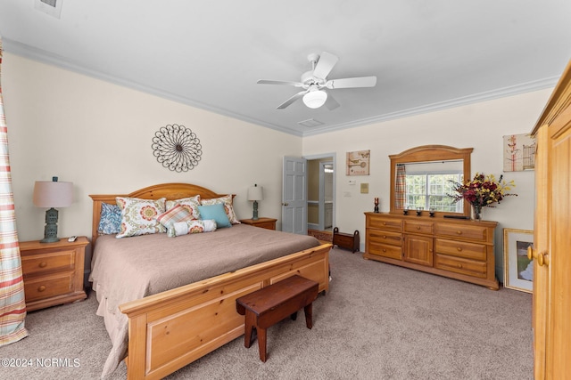 carpeted bedroom featuring visible vents, ornamental molding, and a ceiling fan