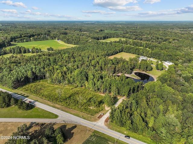 drone / aerial view with a wooded view