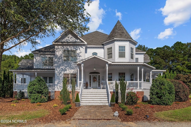 victorian house featuring covered porch