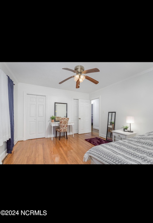 bedroom with light wood finished floors, baseboards, and ceiling fan