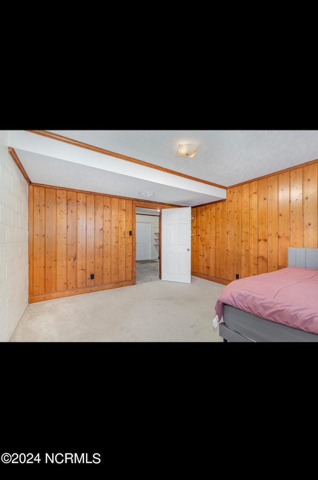 bedroom with wooden walls, light carpet, and billiards