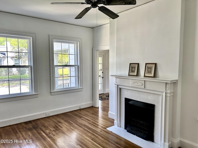living room with a healthy amount of sunlight, baseboards, ceiling fan, and wood finished floors