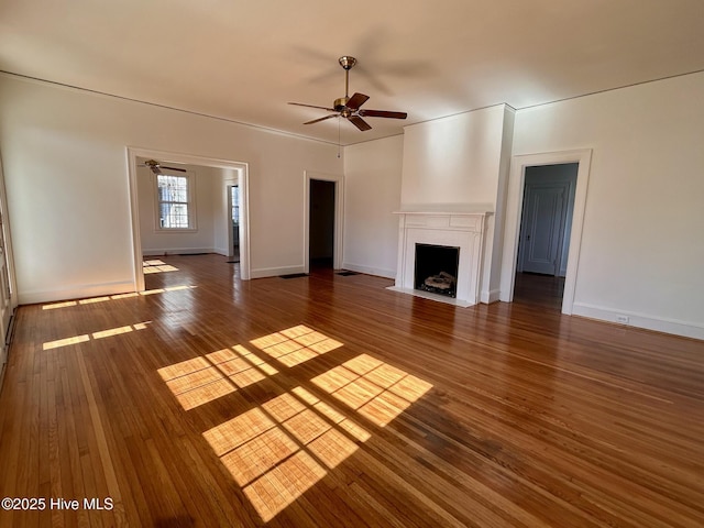 unfurnished living room with ceiling fan and dark hardwood / wood-style flooring