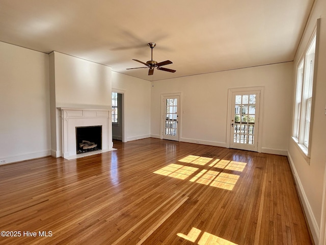 unfurnished living room with hardwood / wood-style flooring and ceiling fan