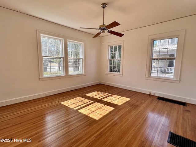 unfurnished room with hardwood / wood-style flooring, ceiling fan, and plenty of natural light