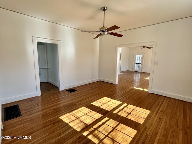 spare room featuring wood-type flooring and ceiling fan