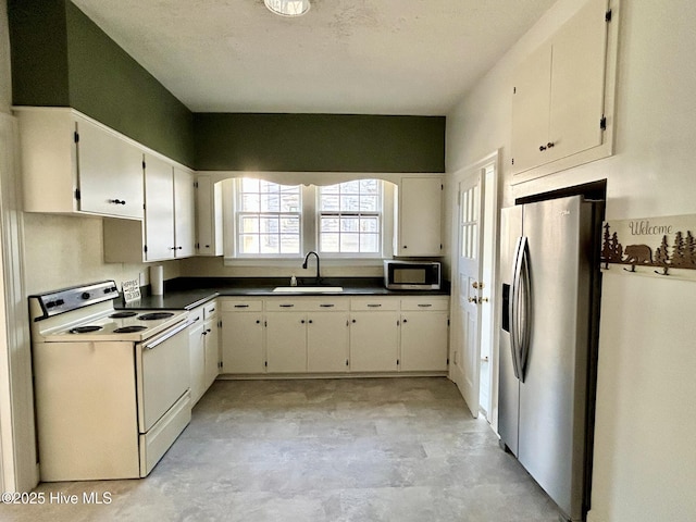 kitchen with white cabinetry, sink, and stainless steel appliances