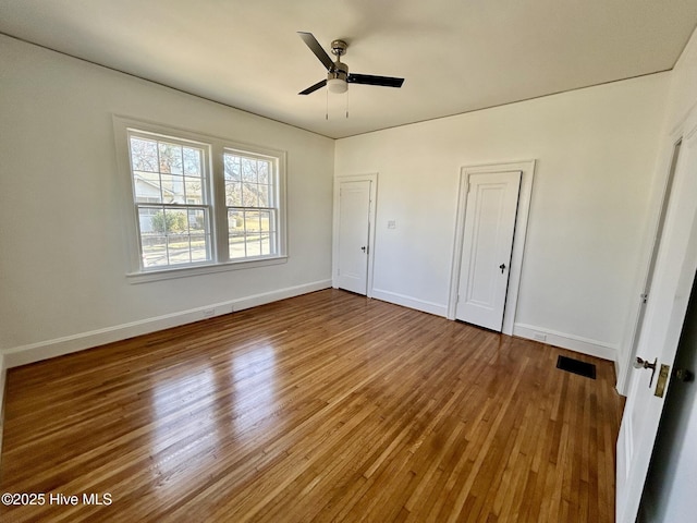 unfurnished bedroom with ceiling fan and hardwood / wood-style floors