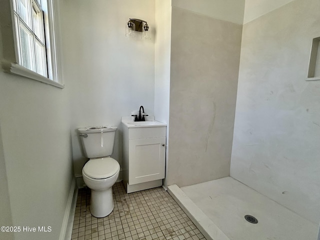 bathroom featuring tile patterned floors, toilet, vanity, and a shower