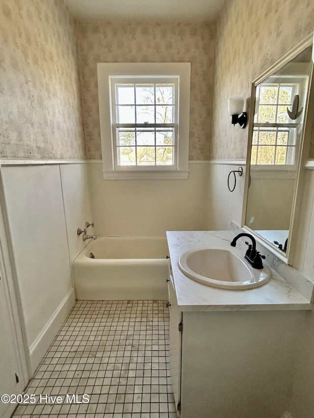 bathroom featuring a tub to relax in, vanity, tile patterned flooring, and plenty of natural light