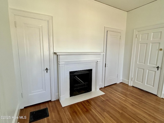 unfurnished living room featuring hardwood / wood-style flooring