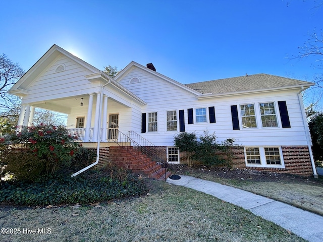 view of front of house featuring a front yard and a porch