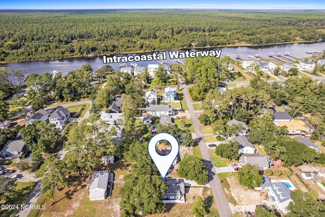 aerial view with a residential view, a water view, and a wooded view