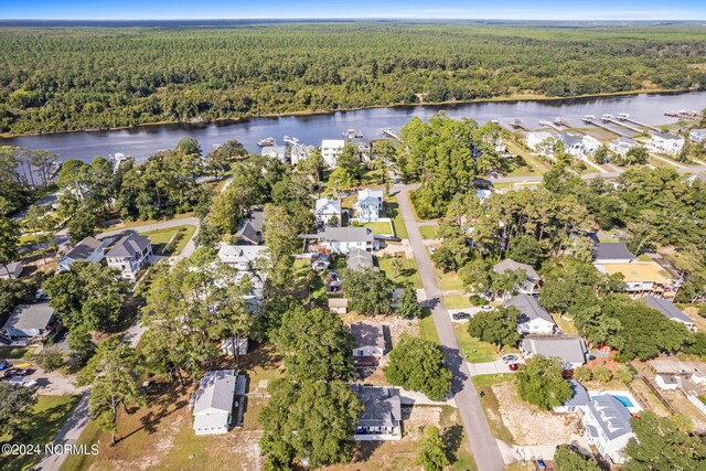 127 NW 19th St, Oak Island, NC 28465 - view of property location featuring a forest, a nearby body of water, and nearby suburban area