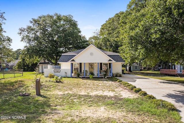 127 NW 19th St, Oak Island, NC 28465 - bungalow-style home with covered porch, driveway, and a shingled roof