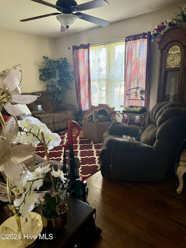 living room with hardwood / wood-style floors and ceiling fan