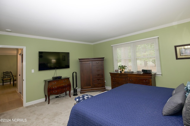 bedroom featuring crown molding, baseboards, and light colored carpet