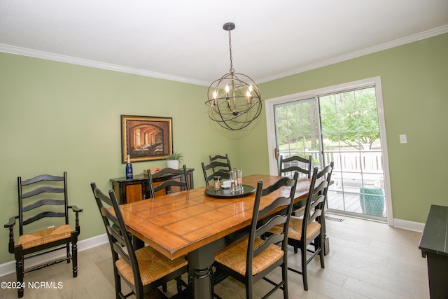 dining space with crown molding, baseboards, light wood-style floors, and a chandelier