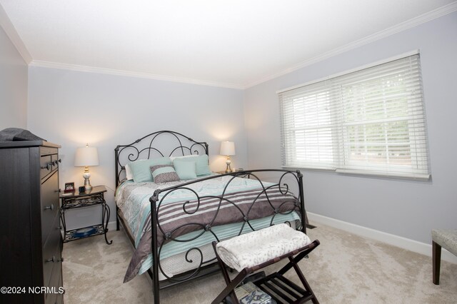 bedroom with crown molding, baseboards, and carpet