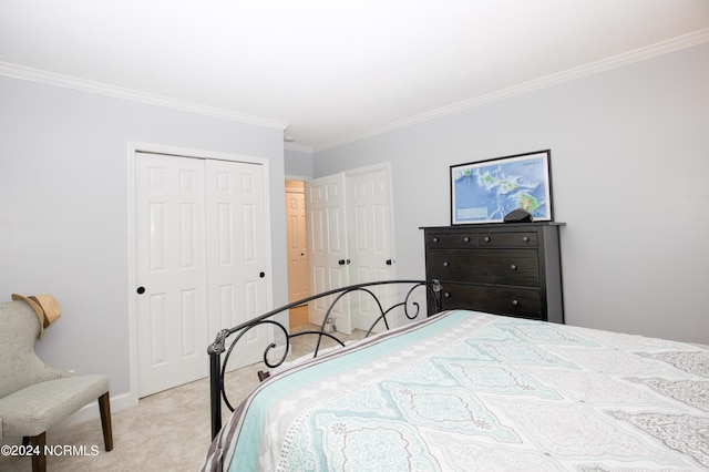 carpeted bedroom with ornamental molding and a closet