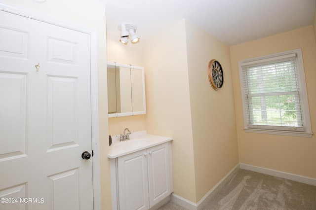 bathroom featuring baseboards and vanity