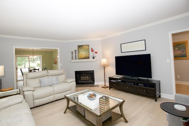 living room with ornamental molding, wood finished floors, and a chandelier