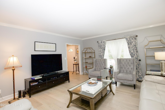living room featuring baseboards, ornamental molding, and wood finished floors