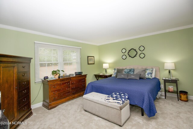 carpeted bedroom featuring crown molding and baseboards