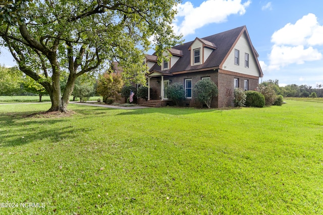 view of side of property with a lawn