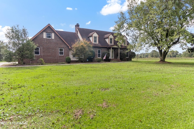 cape cod home featuring a front lawn