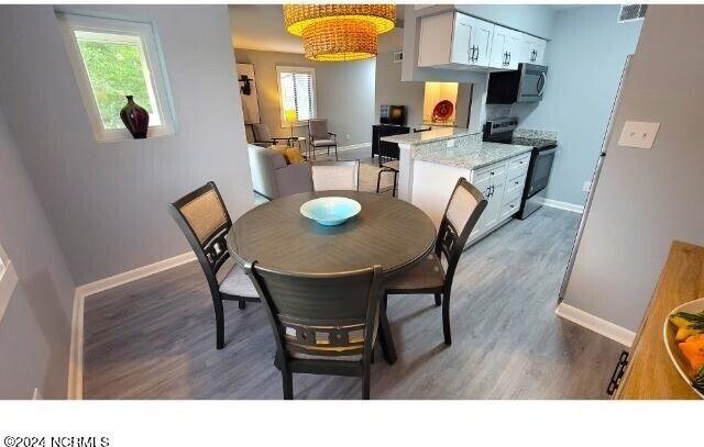 10166 Beach Dr SW Unit 5306, Calabash, NC 28467 - dining room featuring plenty of natural light and light wood-style floors