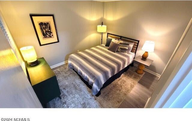 10166 Beach Dr SW Unit 5306, Calabash, NC 28467 - bedroom with baseboards and wood finished floors